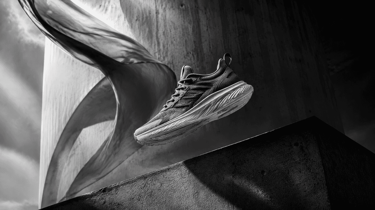 16:9 black-and-white cinematic commercial photograph, premium luxury advertising aesthetic.An…