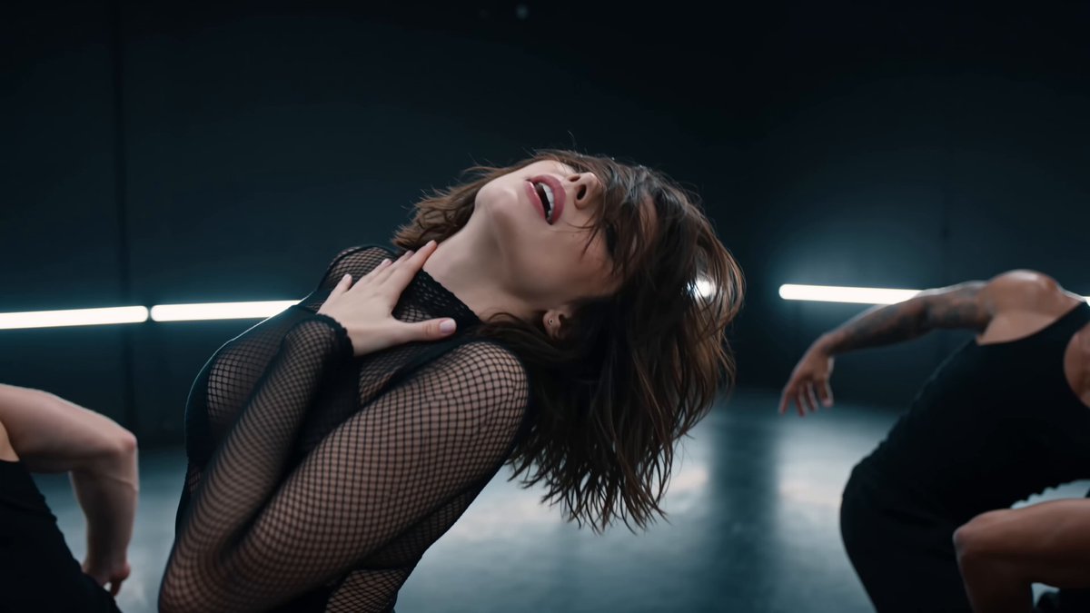 A cinematic 15-second music video shot in a dark…